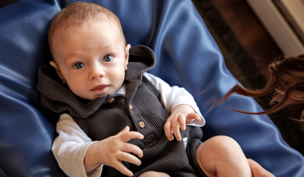 Infant laying down and smiling