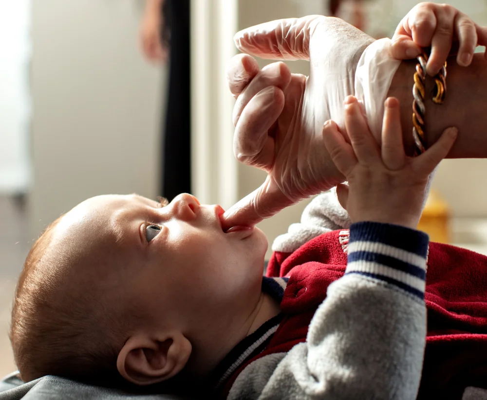 Female chiropractor assesses infant for tongue tie
